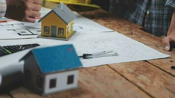 Construction and structure concept of Engineer or architect meeting for project working with partner and engineering tools on model building and blueprint in working site, contract for both companies. video