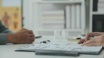 Doctor and patient are discussing consultation about symptom problem diagnosis of disease talk to the patient about medication and treatment method. video