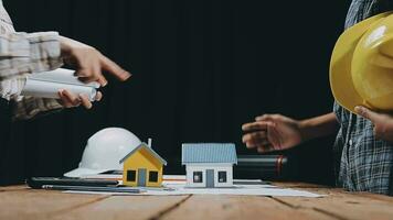 Image of team engineer checks construction blueprints on new project with engineering tools at desk in office. video