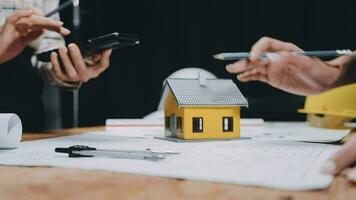 Image of team engineer checks construction blueprints on new project with engineering tools at desk in office. video