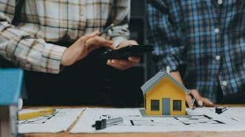 Image of team engineer checks construction blueprints on new project with engineering tools at desk in office. video
