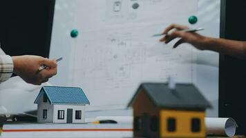 Image of team engineer checks construction blueprints on new project with engineering tools at desk in office. video