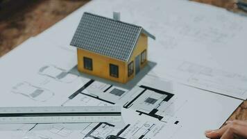 Image of team engineer checks construction blueprints on new project with engineering tools at desk in office. video