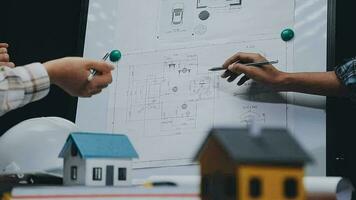 Image of team engineer checks construction blueprints on new project with engineering tools at desk in office. video