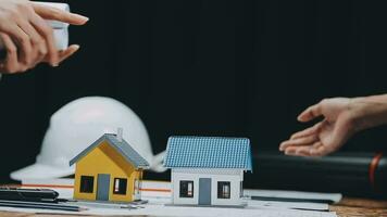 Image of team engineer checks construction blueprints on new project with engineering tools at desk in office. video