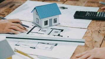 Image of team engineer checks construction blueprints on new project with engineering tools at desk in office. video