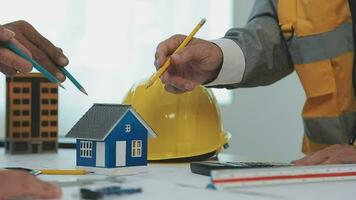 Construction and structure concept of Engineer or architect meeting for project working with partner and engineering tools on model building and blueprint in working site, contract for both companies. video