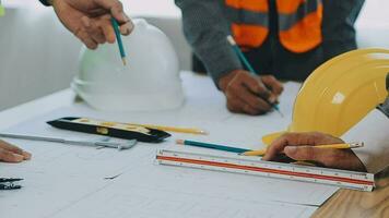 Construction and structure concept of engineer working drawing on blueprint meeting for project working with partner on model building and engineering tools in working site, construction concept. video