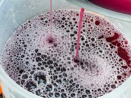 The process of making homemade grape wine. The operation of a hydraulic press to obtain grape juice for fermentation. photo