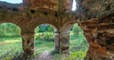 circular rotation of ruined abandoned building with arches without roof with bushes video