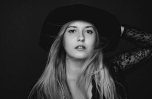 Beautiful blonde woman wearing a hat, artistic film portrait in black and white for fashion campaign and beauty brand photo