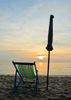 Colorful beach chair in sunrise at Cha-Am beach, Thailand photo