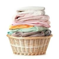 Wicker basket with clean laundry isolated photo