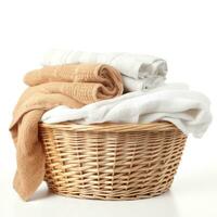 Wicker basket with clean laundry isolated photo