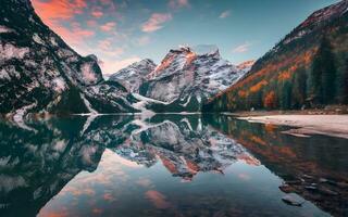 Radiant Sunrise Embrace, A Captivating Portrait of Tranquility at a Majestic Mountain Lake. AI Generated photo