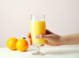 Hand with glass of orange juice photo