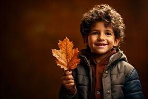 A child marveling at a leaf isolated on an autumn gradient background photo