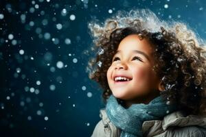 A child catching falling snowflakes isolated on a winter gradient background photo