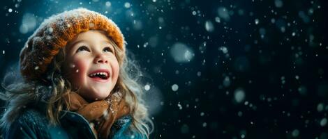A child catching falling snowflakes isolated on a winter gradient background photo