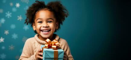 Excited child unwrapping a gift isolated on a festive gradient background photo