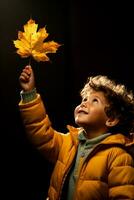 A child marveling at a leaf isolated on an autumn gradient background photo