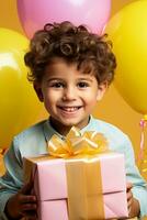 A child joyously holding a birthday present isolated on a vibrant gradient background photo