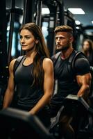 Serious gym goers handling robust resistance machines during intense strength training at fitness club photo