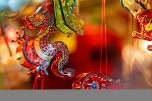 Decorated colorful lanterns hanging on a stand in the streets in Ho Chi Minh City, Vietnam during Mid Autumn Festival. Chinese language in photos mean money and happiness