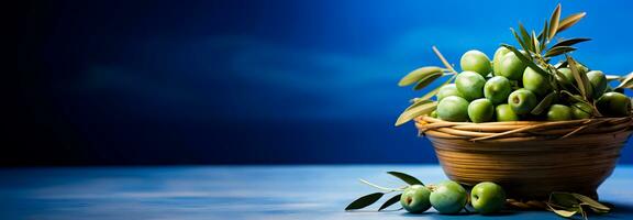 A basket full of fresh olives on a sunny day isolated on a Mediterranean blue gradient background photo