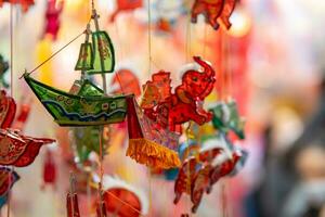 Decorated colorful lanterns hanging on a stand in the streets in Ho Chi Minh City, Vietnam during Mid Autumn Festival. Chinese language in photos mean money and happiness