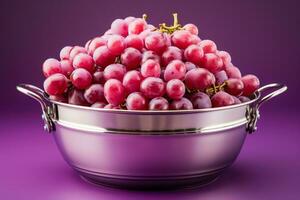 A stainless steel basket filled with sorted grapes isolated on a gradient background photo