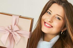 Winter holidays, present and Merry Christmas concept, happy woman smiling and holding wrapped gift box photo