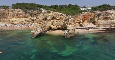 Drone video over Algarve cliffs near Praia do Marinha beach during daytime