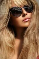 Luxury fashion, travel and beauty face portrait of young blonde woman, wearing chic sunglasses, suntanned skin and long beach waves hairstyle, summer accessory and glamour style photo