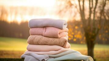 Laundry, housekeeping and homemaking, stack of clean and folded knitted clothes in the countryside, generative ai photo