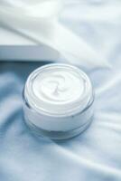 Luxury face cream jar and white gift box photo