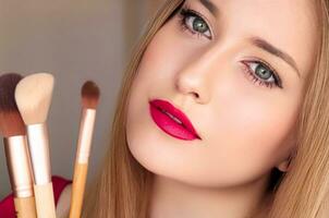 Beauty, makeup and cosmetics, face portrait of beautiful woman with make-up brushes, luxury cosmetic product, makeup artist or beauty blogger concept photo