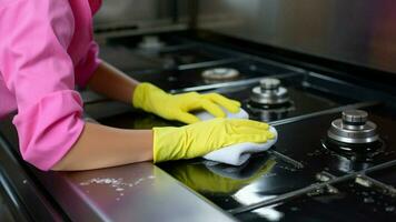 Enjoying household duties Gloved female hand cleans stove, housewifes satisfaction palpable AI Generated photo