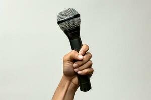 A raised hand clutches a microphone, set against an isolated white backdrop. AI Generated photo