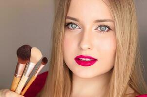 Beauty, makeup and cosmetics, face portrait of beautiful woman with make-up brushes, luxury cosmetic product, makeup artist or beauty blogger concept photo
