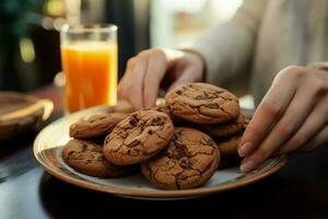 In detail Hand snags chocolate cookies, juggles them with an orange juice AI Generated photo