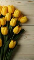 Topdown shot of yellow tulips on a white wooden background Vertical Mobile Wallpaper AI Generated photo