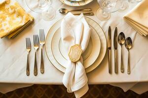 Elegant dinner table setting arrangement in English country style as flatlay tablescape, folded napkin on a serving plate, tableware and holiday table decor, generative ai photo