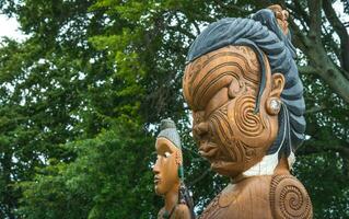 The cropped shot view of the traditional Maori wood carving statue in Civic square of Hastings, New Zealand. photo