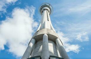 An iconic sky tower of Auckland the largest city in New Zealand. View from below. photo