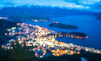 The blur bokeh city nightlife of Queenstown at dusk, New Zealand. photo