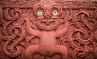 The traditional wood carving in traditional Maori garden in Hamilton gardens an iconic garden in Hamilton, New Zealand. photo