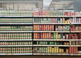 Solo, Indonesia - February, 2023 - display rack of various canned food products in a supermarket photo