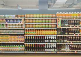 Solo, Indonesia - February, 2023 - drinking water of various brands in the supermarket above the window photo