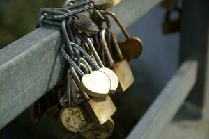 Many Padlocks Closed on Bridge Fence - Love Concept photo